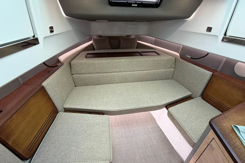 Slide: The Image of 2023 Axopar 45 XC Cross Cabin interior with modern seating and wood accents. - 31