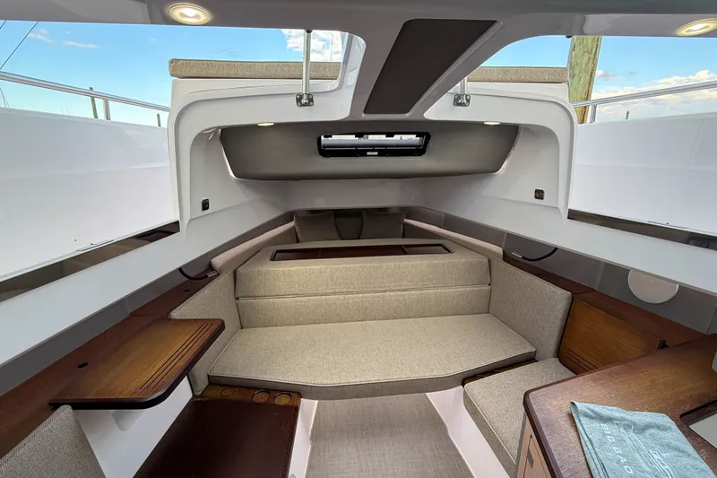 Slide: The Image of Interior of 2023 Axopar 45 XC Cross Cabin, featuring modern seating and wooden accents. - 32