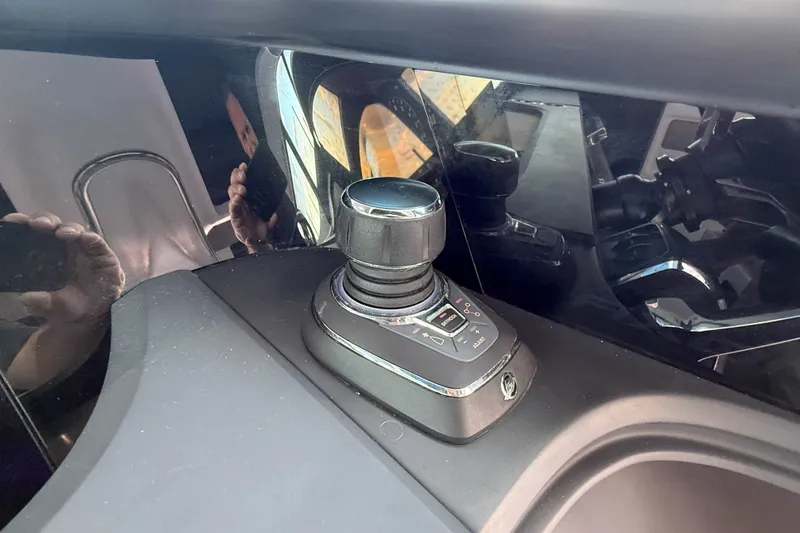 Slide: The Image of Joystick control in 2023 Axopar 45 XC Cross Cabin boat cockpit. - 24