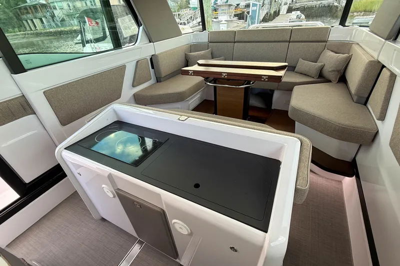 Slide: The Image of Interior of 2023 Axopar 45 XC Cross Cabin with seating and kitchenette. - 16