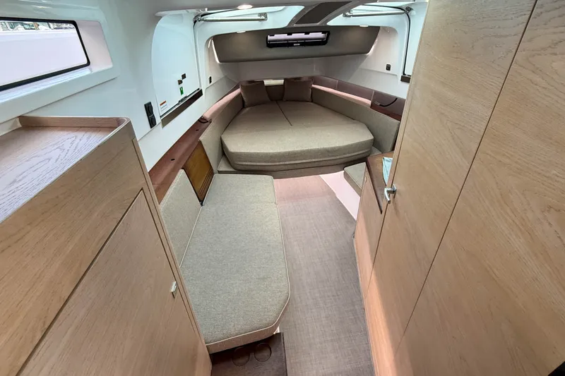 Slide: The Image of Interior of 2023 Axopar 45 XC Cross Cabin, featuring modern wood finishes and cozy seating. - 28