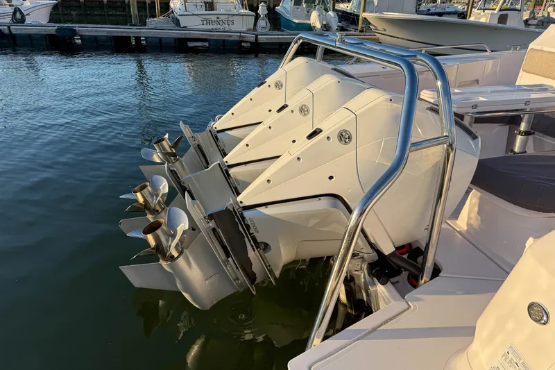 Slide: The Image of 2023 Axopar 45 XC Cross Cabin with triple outboard engines at dock. - 38
