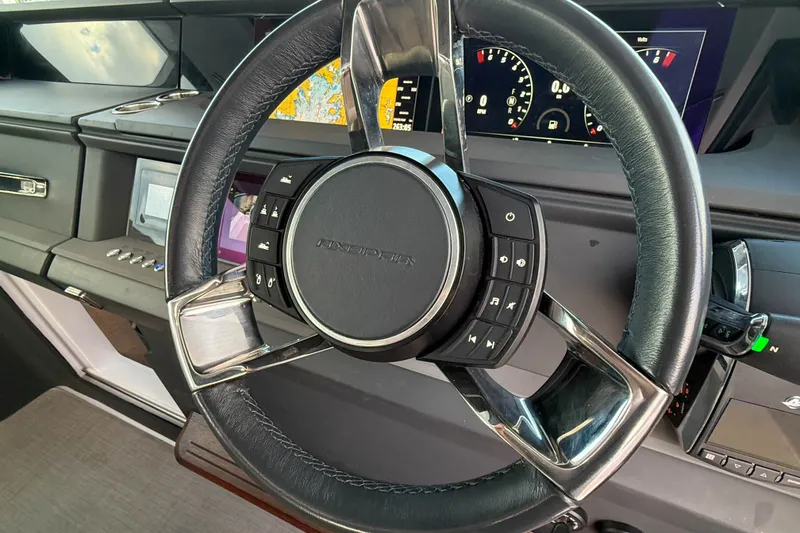 Slide: The Image of Steering wheel of 2023 Axopar 45 XC Cross Cabin with digital dashboard display. - 23