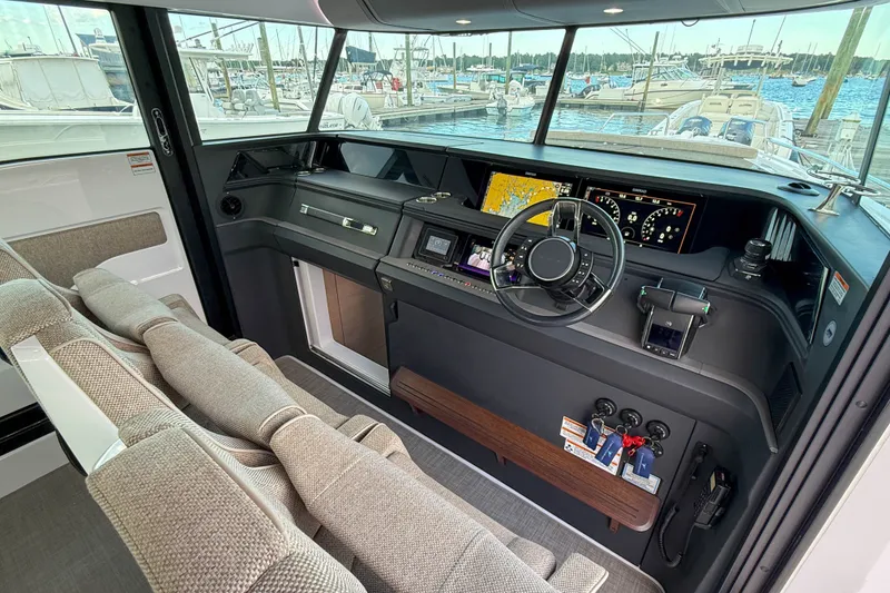 Slide: The Image of 2023 Axopar 45 XC Cross Cabin interior with modern dashboard and navigation controls. - 21