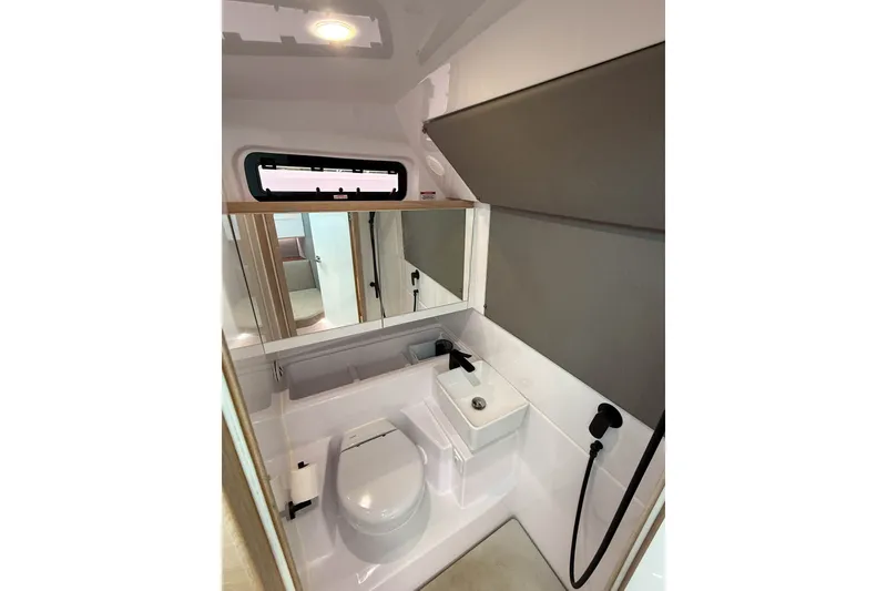 Slide: The Image of 2023 Axopar 45 XC Cross Cabin bathroom with modern fixtures and compact design. - 35