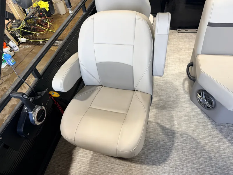 Slide: The Image of A beige captain's chair with armrests on a boat, surrounded by gray carpeting. - 22