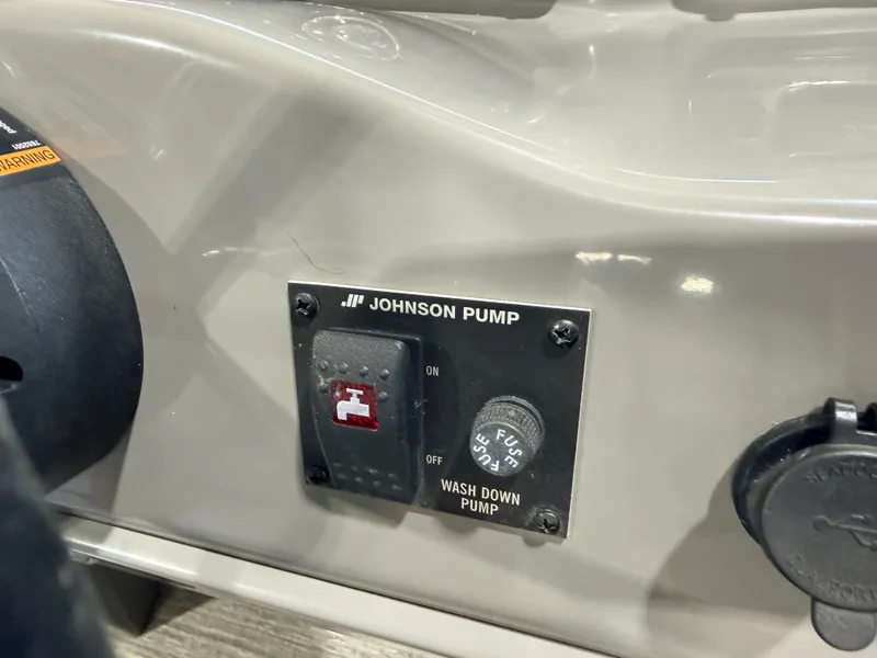 Slide: The Image of Close-up of a control panel with Johnson pump and switches. - 28