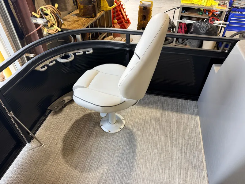 Slide: The Image of A single white seat on a boat with gray flooring and black railing. - 17