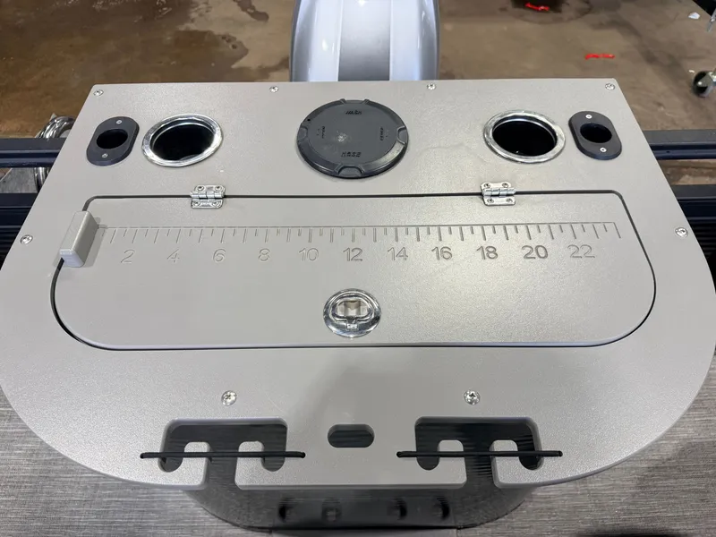 Slide: The Image of The image shows a gray boat dashboard with cup holders and a ruler in inches. - 47