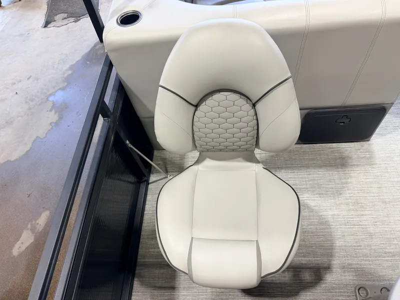 Slide: The Image of A sleek, cushioned seat with a honeycomb pattern on a boat, surrounded by modern interior. - 43