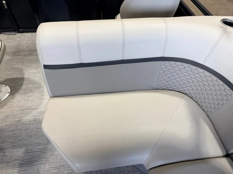 Slide: The Image of A sleek, cream-colored seat with gray accents and a honeycomb pattern on a boat. - 37