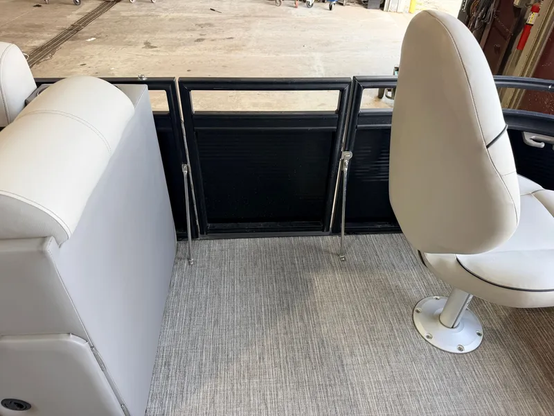 Slide: The Image of Boat interior with gray carpet, a white seat, and a black railing. - 14