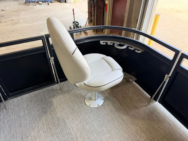 Slide: The Image of A white seat on a boat with black railing and gray flooring. - 12