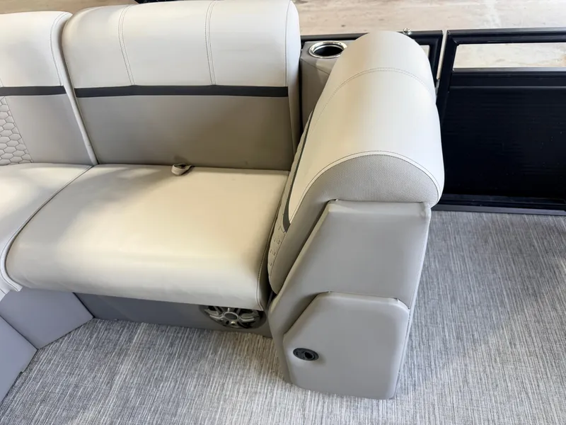 Slide: The Image of Gray upholstery on a boat seat with cup holder and speaker. - 33