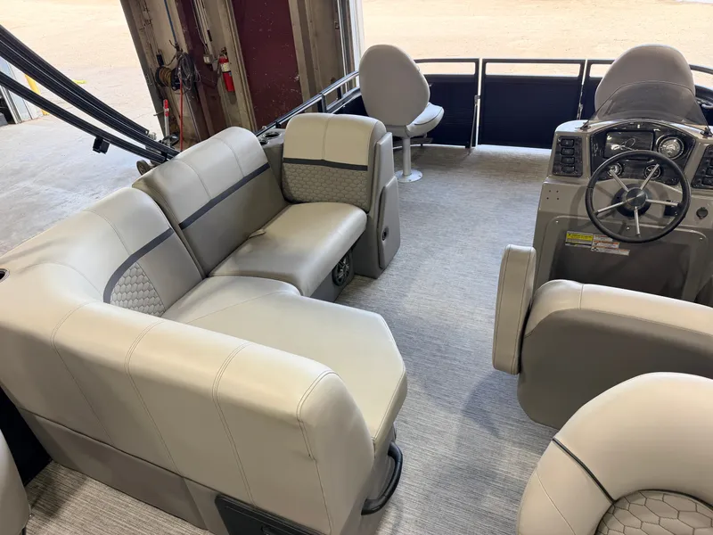 Slide: The Image of Interior of a modern pontoon boat with beige seating and a helm station. - 5