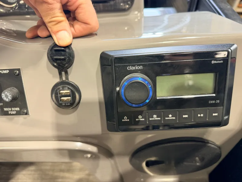 Slide: The Image of Close-up of a boat panel featuring a Clarion audio system and USB ports. - 27