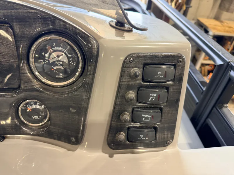 Slide: The Image of Boat dashboard with switches and gauges. - 26