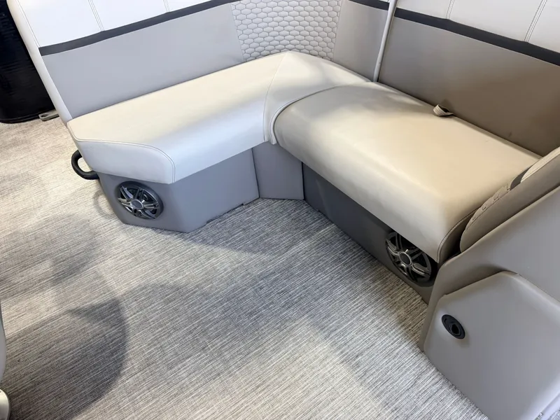 Slide: The Image of The interior view of a boat features an L-shaped bench seat with speakers underneath. - 38