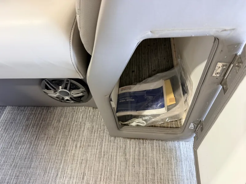 Slide: The Image of An open storage compartment with a speaker beside it and carpeted flooring. - 34