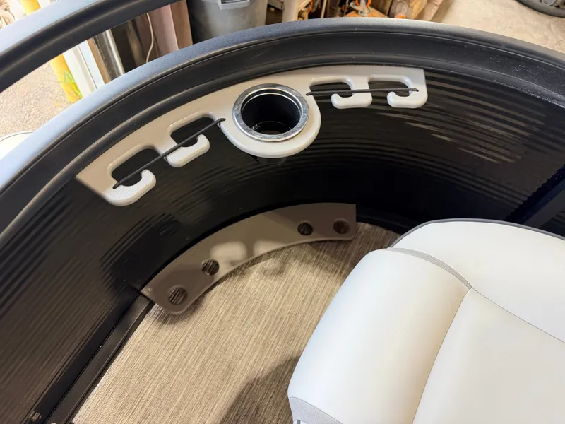 Slide: The Image of Close-up of a boat interior featuring a cup holder and seat upholstery. - 18