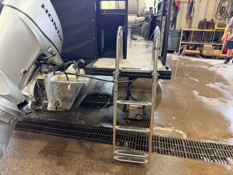 Slide: The Image of A boat ladder leads into the water, next to a Honda outboard motor. - 39