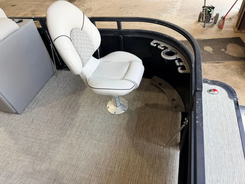 Slide: The Image of A sleek seat on a modern boat with carpeted flooring and cup holders. - 10