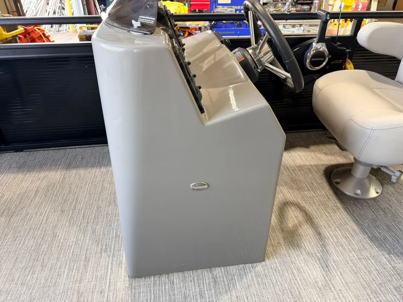Slide: The Image of The image shows a boat's helm with a gray dashboard and a beige seat. - 21