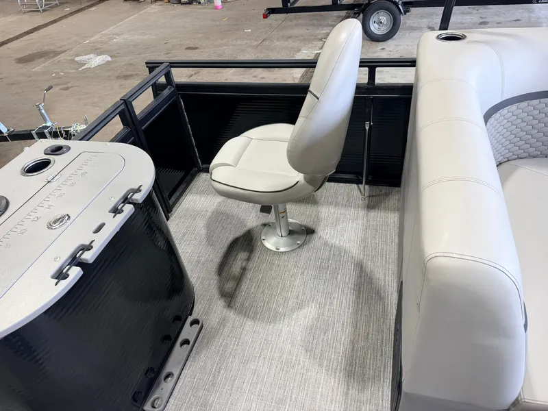Slide: The Image of A modern boat seat with gray upholstery and a console on a carpeted floor. - 41