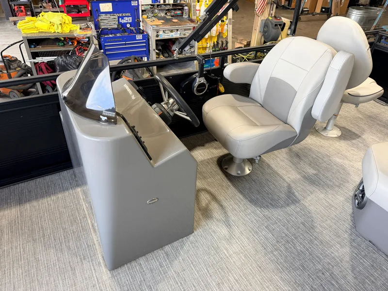 Slide: The Image of Interior view of a boat with a gray helm station and a comfortable, cushioned captain's chair. - 20