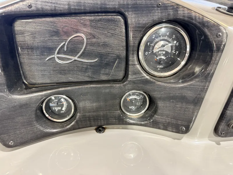 Slide: The Image of The image shows a boat dashboard with a tachometer and other instruments. - 24