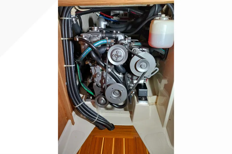 Slide: The Image of Engine compartment of a 2002 Pacific Seacraft Dana 24 sailboat, showcasing mechanical components. - 23