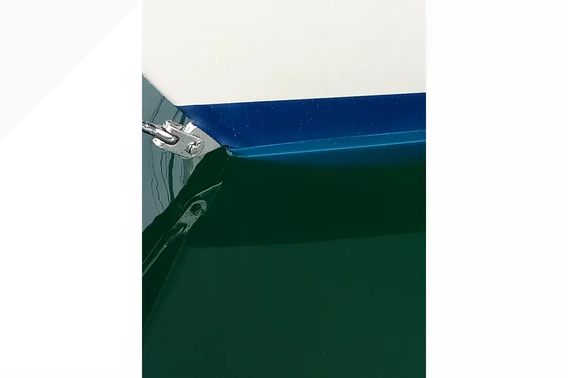 Slide: The Image of Close-up of a 2002 Pacific Seacraft Dana 24 boat hull with blue and white detailing. - 30