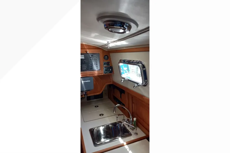 Slide: The Image of Interior of 2002 Pacific Seacraft Dana 24 sailboat, featuring a compact galley with sink. - 39