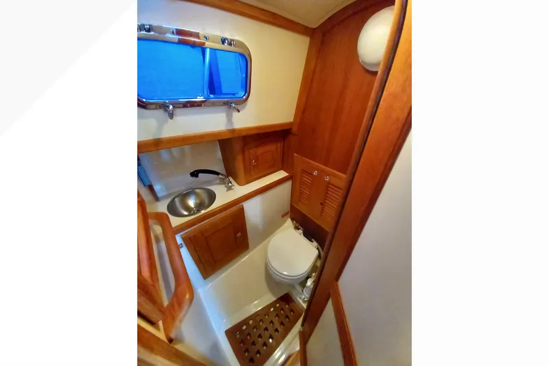 Slide: The Image of Compact wooden bathroom interior of 2002 Pacific Seacraft Dana 24 sailboat. - 22
