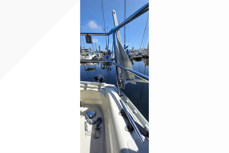 Slide: The Image of 2002 Pacific Seacraft Dana 24 sailboat docked in a marina, showcasing deck details. - 19