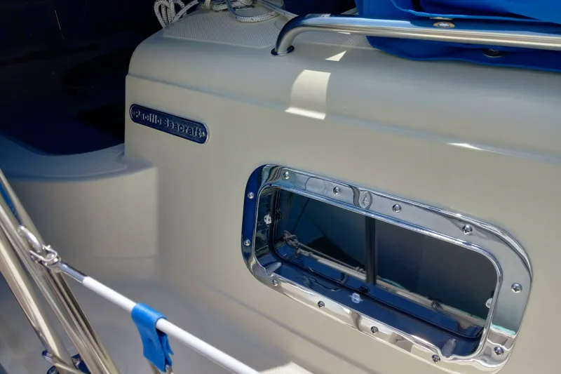 Slide: The Image of Close-up of a 2002 Pacific Seacraft Dana 24 sailboat, showcasing its sleek design and porthole. - 51