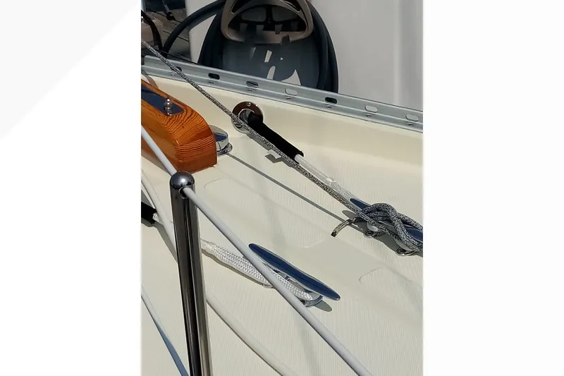 Slide: The Image of Close-up of 2002 Pacific Seacraft Dana 24 sailboat deck with ropes and steering wheel. - 32