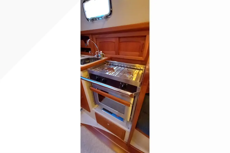 Slide: The Image of Compact galley kitchen in 2002 Pacific Seacraft Dana 24 sailboat with stove and sink. - 37