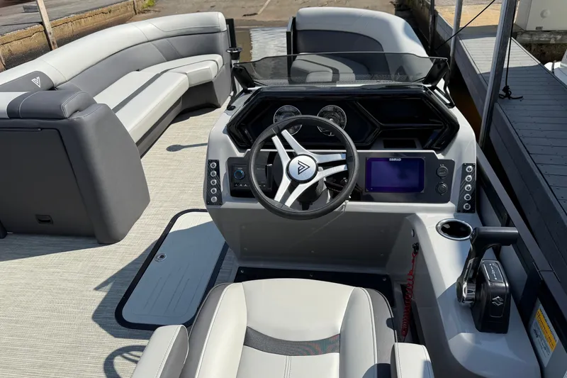 Slide: The Image of Interior view of 2026 Viaggio X24 boat, featuring modern steering console and seating. - 11