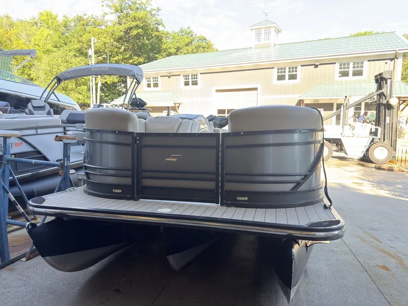 Slide: The Image of A 2019 Starcraft SLS 3 pontoon boat sits on a concrete surface in front of a building. - 15