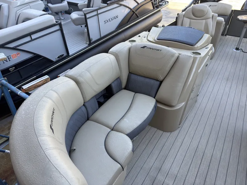 Slide: The Image of The image shows beige leather seating on a 2019 Starcraft SLS 3 pontoon boat. - 19