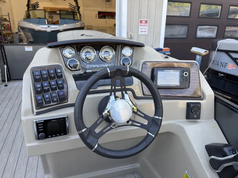 Slide: The Image of The image shows the helm of a 2019 Starcraft SLS 3 with modern instruments. - 23
