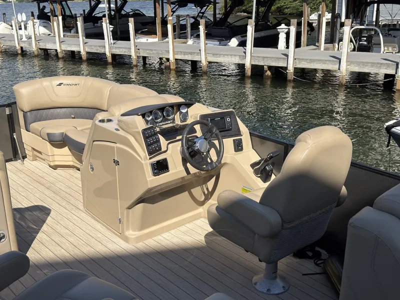 Slide: The Image of The image shows the cockpit of a 2019 Starcraft SLS 3 with beige seating and a modern helm. - 29