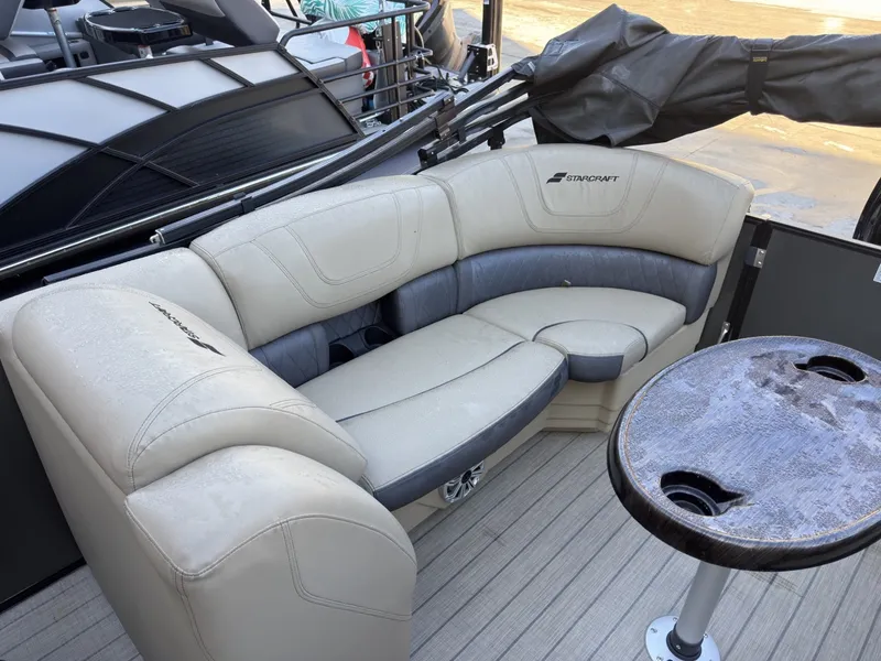 Slide: The Image of The image shows the seating area of a 2019 Starcraft SLS 3 with beige upholstery and a round table. - 25