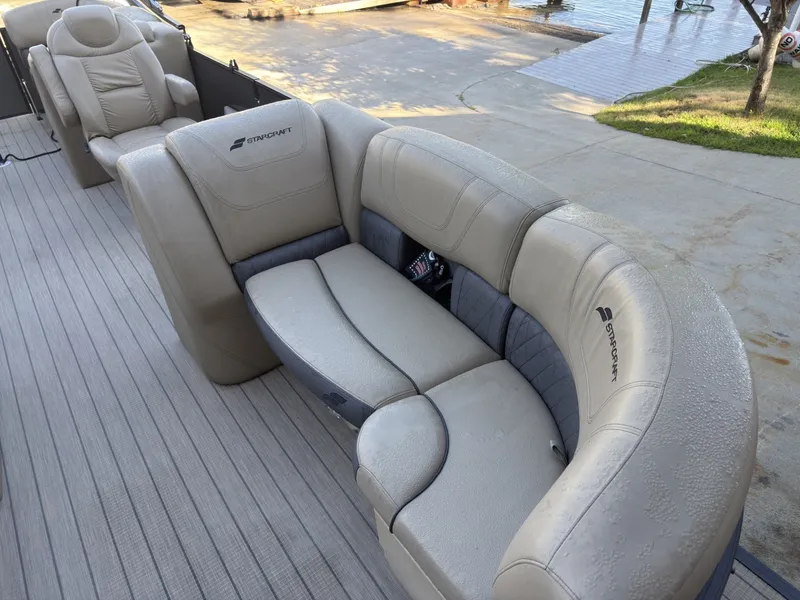 Slide: The Image of The image shows the beige seating of a 2019 Starcraft SLS 3 pontoon boat. - 20