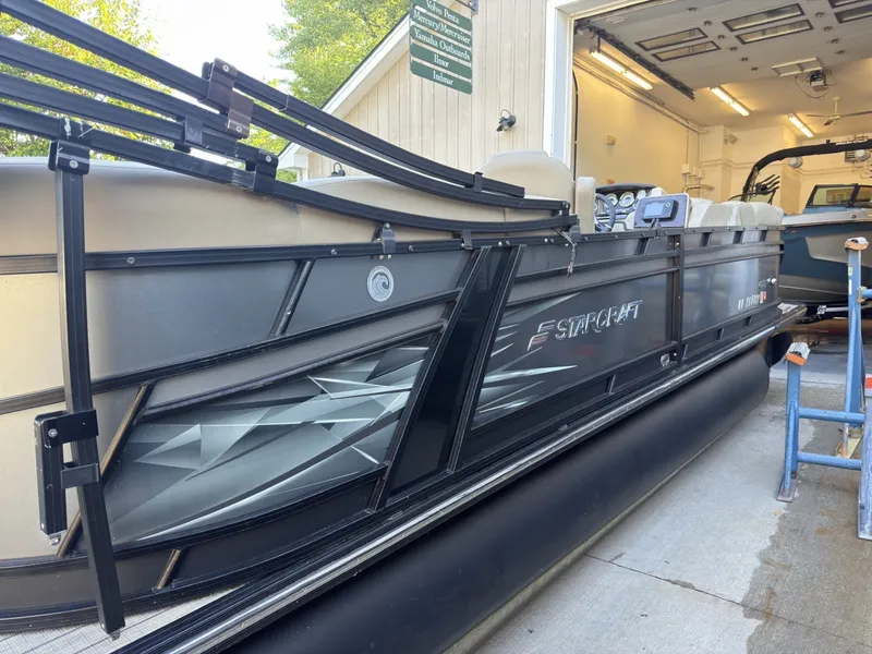 Slide: The Image of A 2019 Starcraft SLS 3 pontoon boat in a garage. - 14