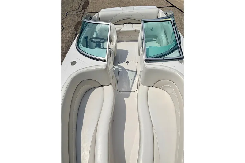 Slide: The Image of 2005 Starcraft 2100 IO RE Limited boat interior with white seating and windshield. - 69