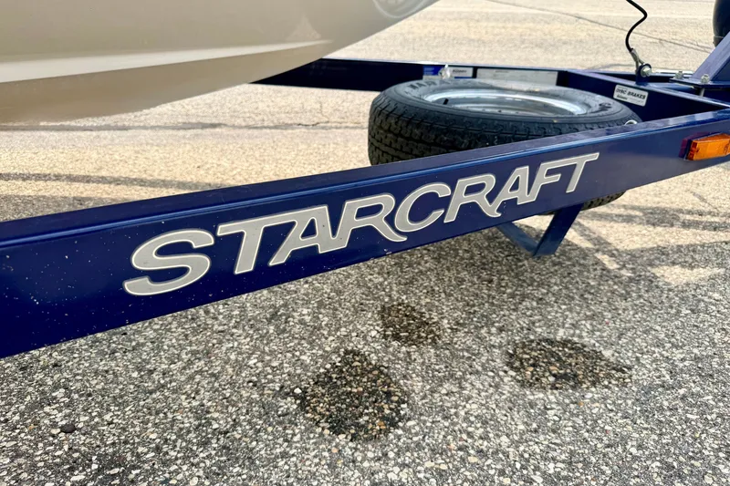 Slide: The Image of Blue Starcraft trailer frame with logo, featuring a spare tire. Model: 2100 IO RE Limited, 2005. - 84