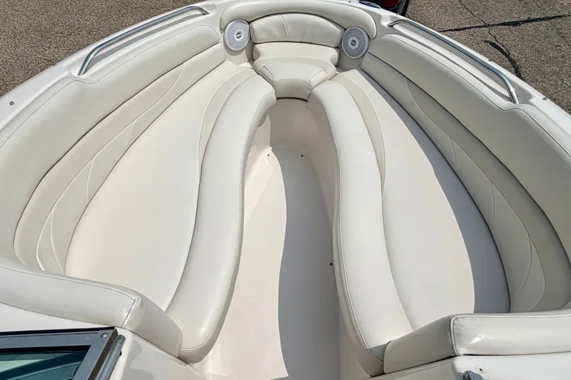 Slide: The Image of Interior of 2005 Starcraft 2100 IO RE Limited boat with white cushioned seating. - 58