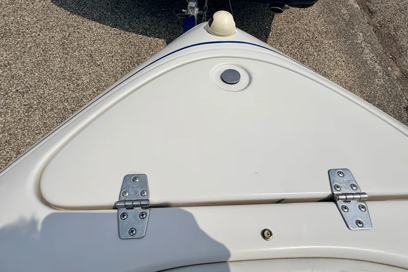 Slide: The Image of Bow of 2005 Starcraft 2100 IO RE Limited boat with hinged compartment. - 67